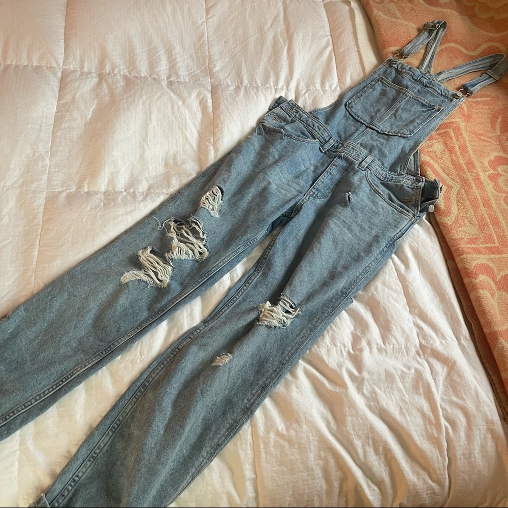 Distressed denim overalls